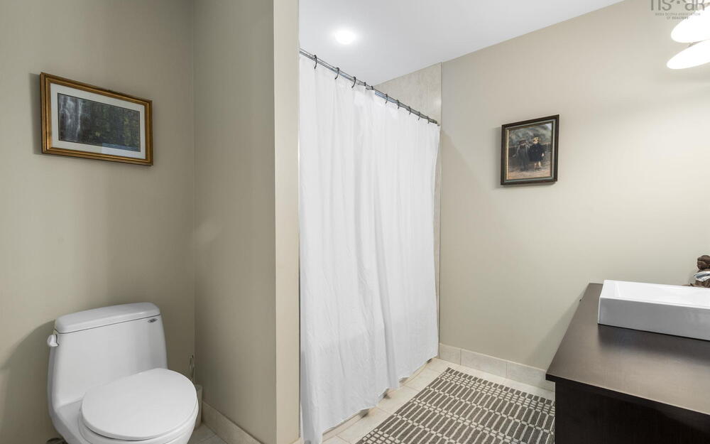 Bathroom featuring vanity, tile patterned floors, and curtained shower